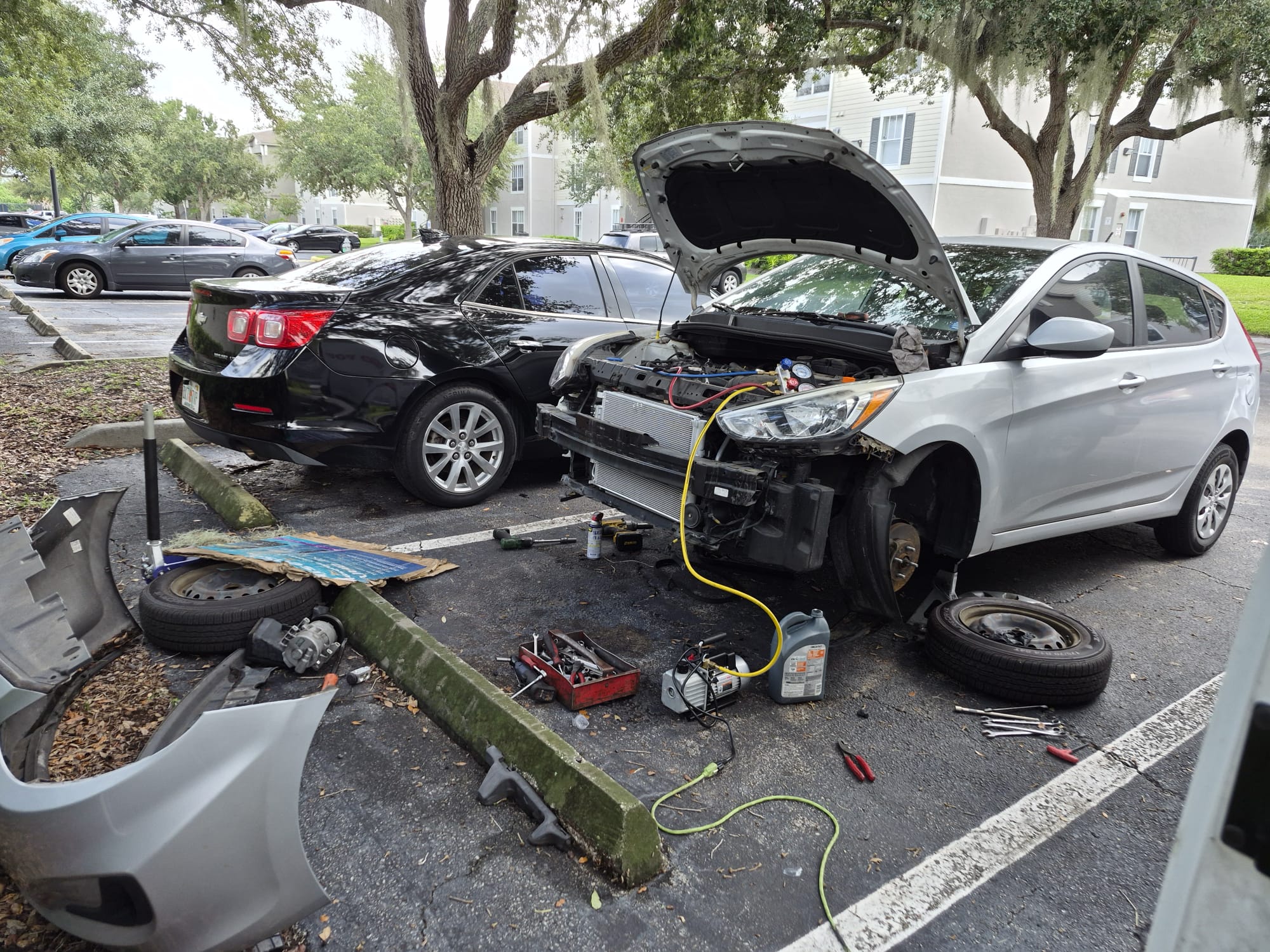 Two cars with one front bumper and radiator removed for repair